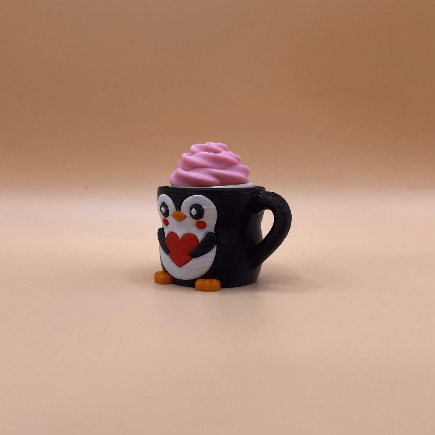 Penguin-shaped mug with pink whipped cream on a beige background