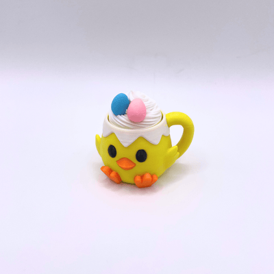 Yellow bird-shaped cup with whipped cream and colorful polka dots on a white background