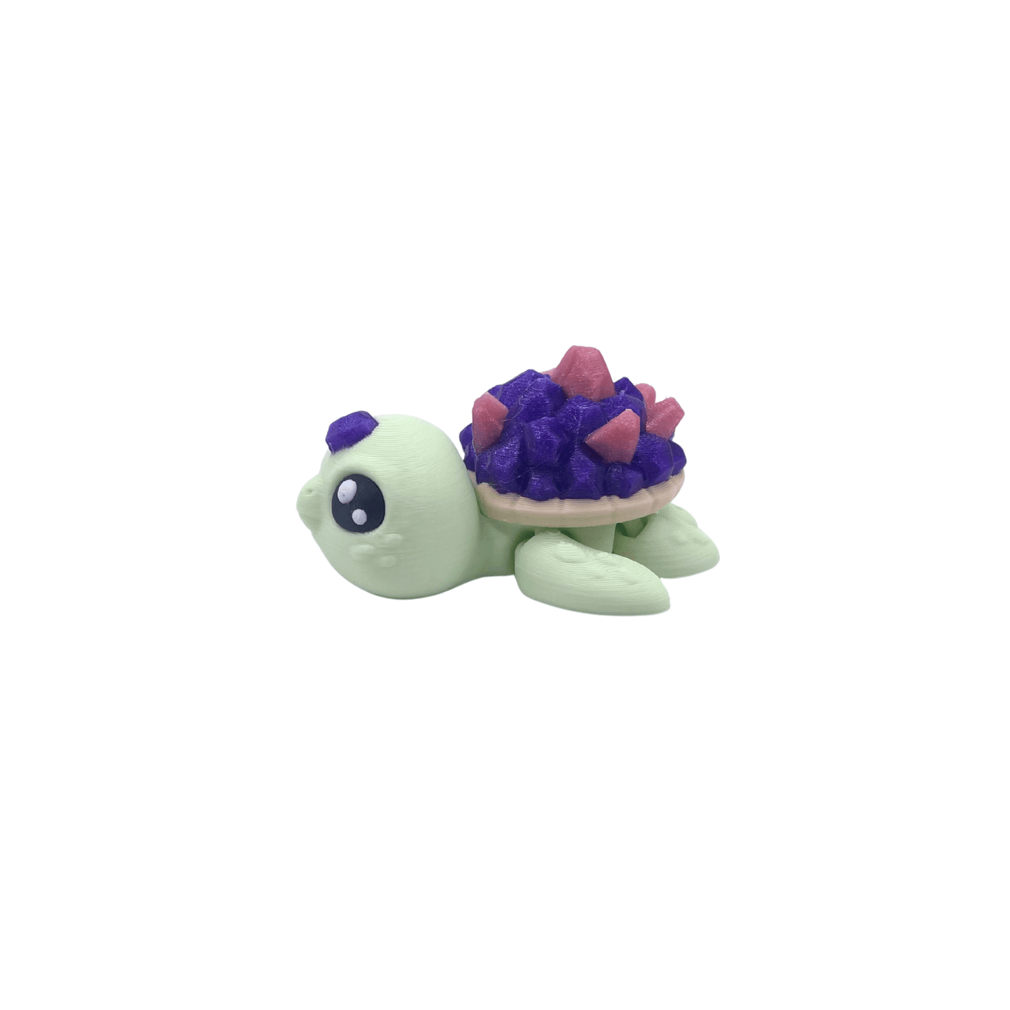Small crystal style turtle figurine with purple shell on a white background