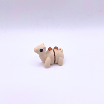 Small beige camel figurine on a white background