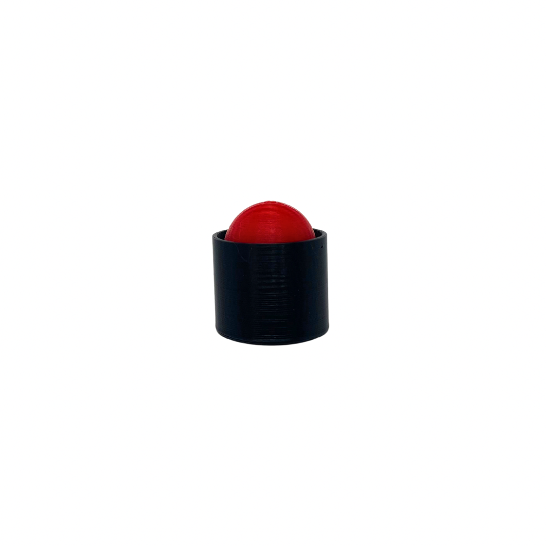 A mini red button fidget clicker with a black body.