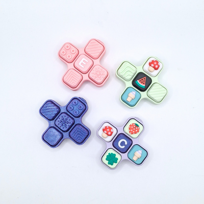 Colorful Tactile Clicker fidget toy with various textures and letter tiles E and C.