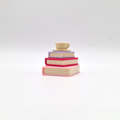 teacup and book pile clicker in pink and purple