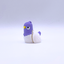 Purple and white bird-shaped object on a light gray background