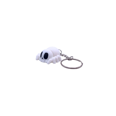 Ghost spider keyring in white silk with black eyes, attached to a metal hoop keychain, perfect for Halloween.