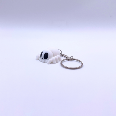 Mini white silk spider keyring with black eyes and keychain, perfect for Halloween decorations.