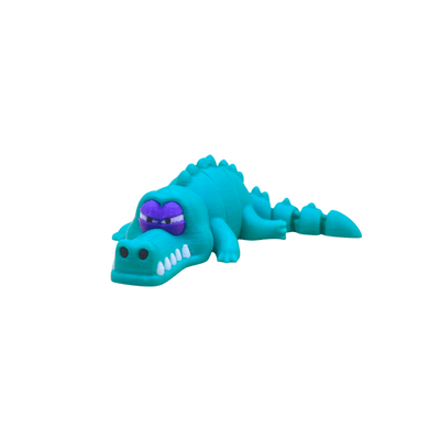 Toy crocodile with a purple eyes on a white background