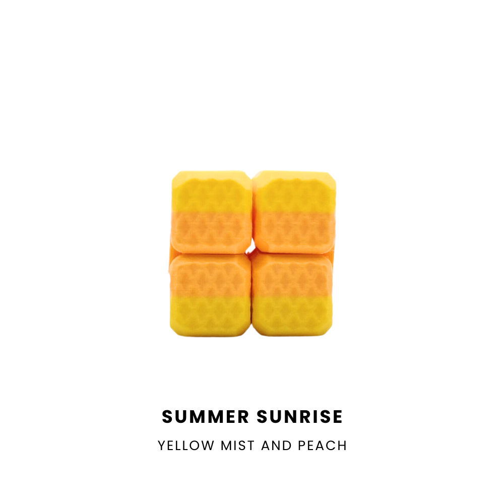Four small square yellow-orange wax melts stacked in a 2x2 grid on a white background, with the text 'SUMMER SUNRISE' and 'YELLOW MIST AND PEACH' below.