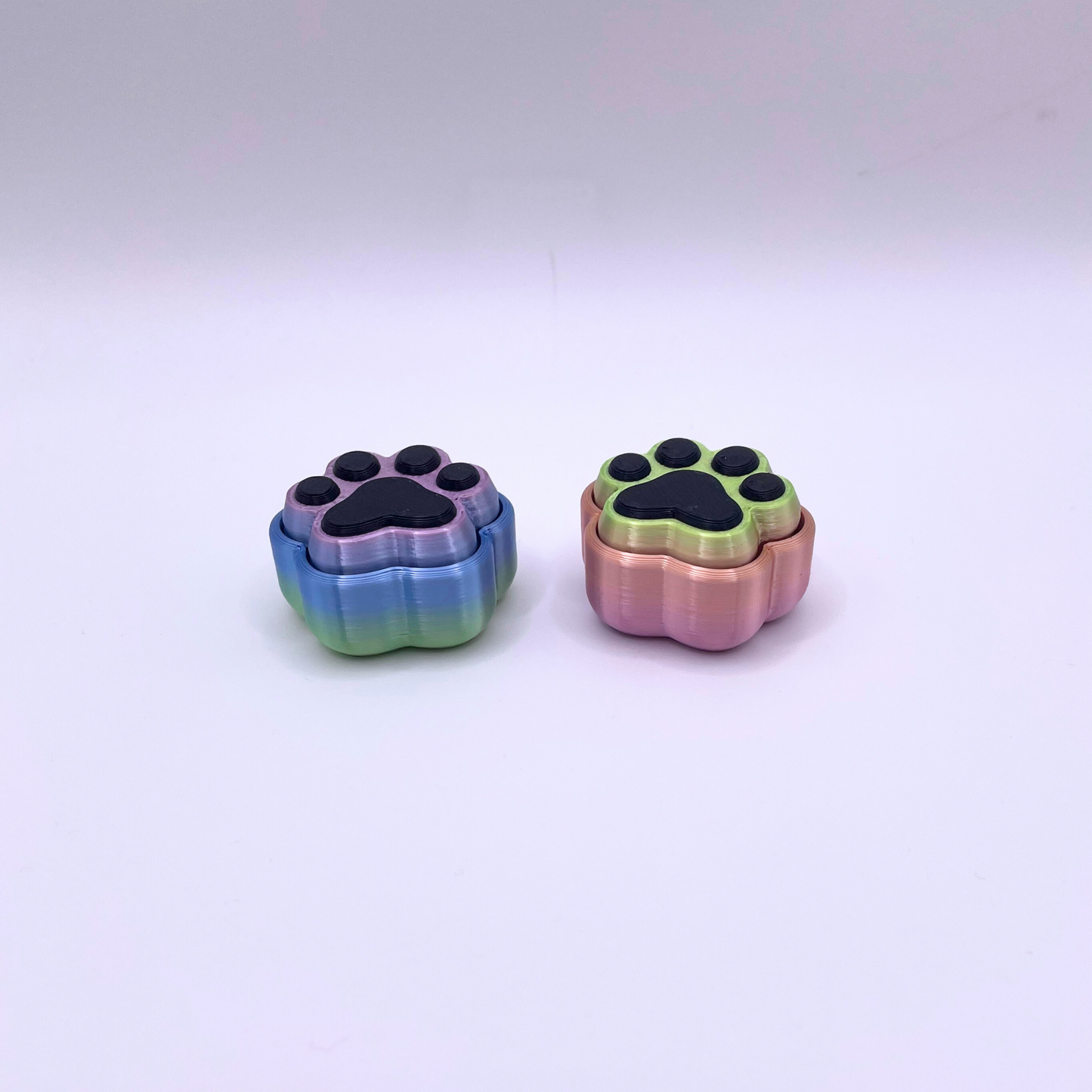 Paw Print Clicker fidget toy in exclusive rainbow design, crisp ASMR clicks for stress relief, focus, and sensory satisfaction.