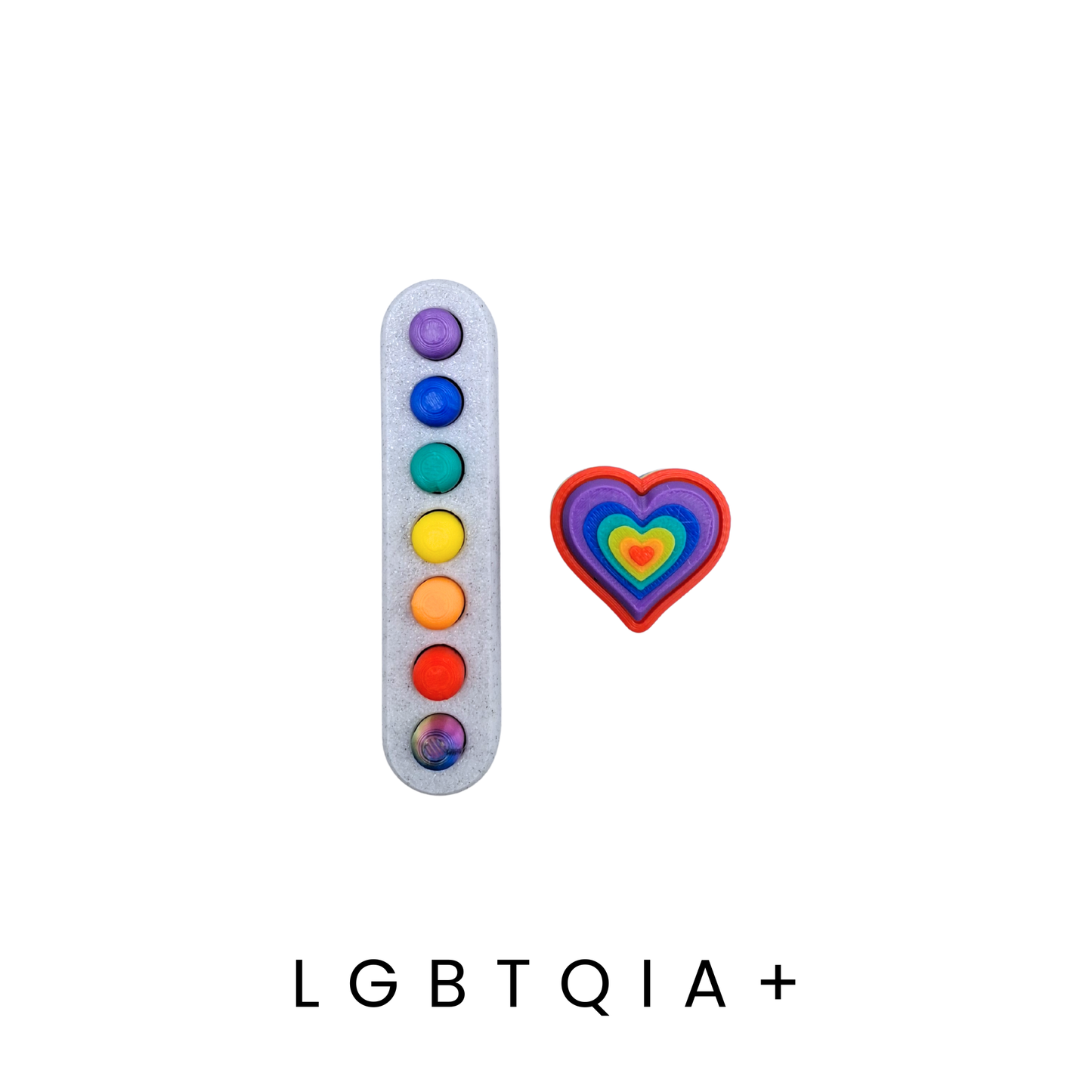 Colorful dot charm and heart-shaped charm with 'LGBTQIA+' text on a white background