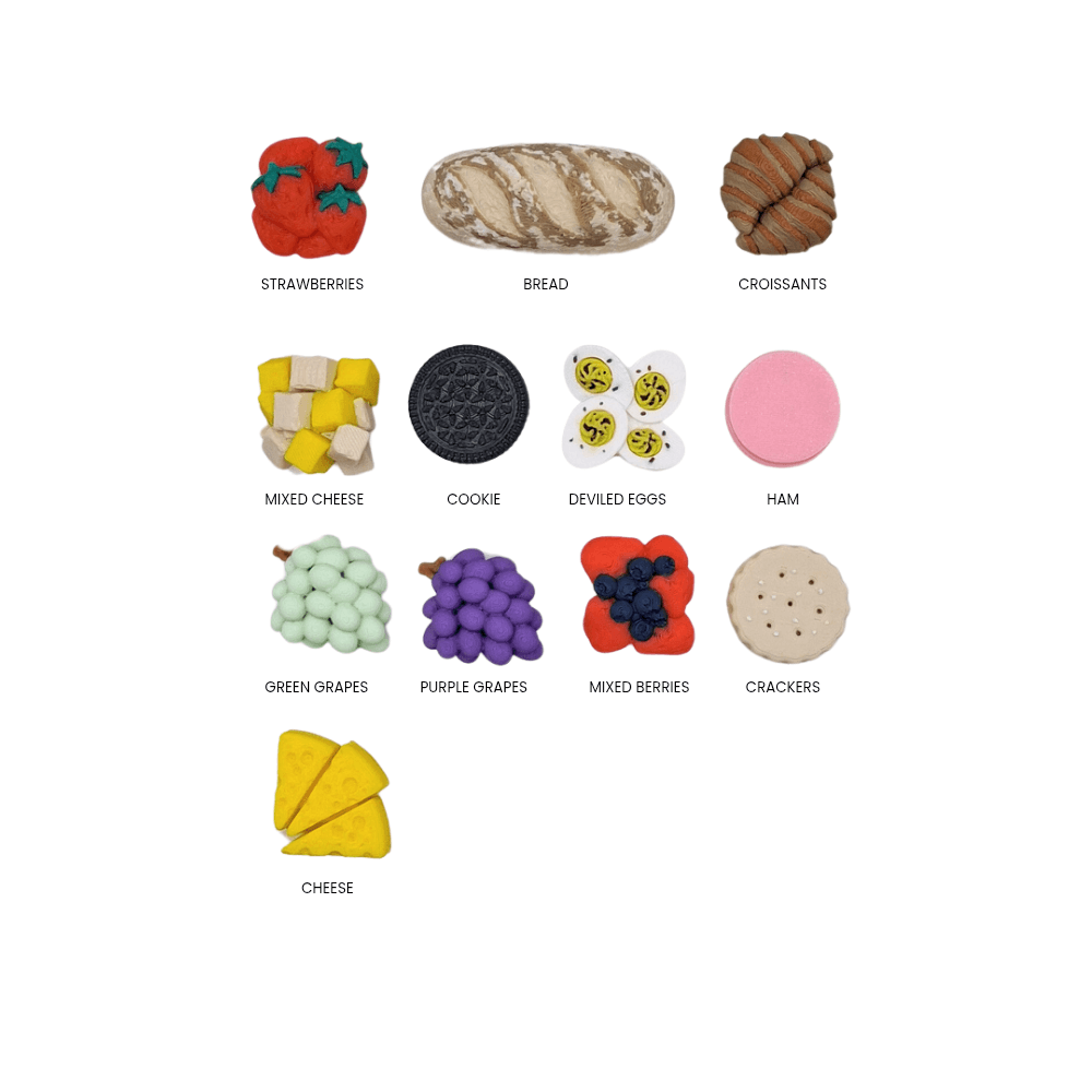 Assorted food items including strawberries, bread, croissants, cheese, cookies, deviled eggs, ham, green grapes, purple grapes, mixed berries, and crackers on a white background.