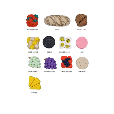 Assorted food items including strawberries, bread, croissants, cheese, cookies, deviled eggs, ham, green grapes, purple grapes, mixed berries, and crackers on a white background.