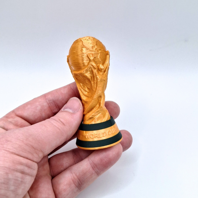 Golden trophy clicker with green band