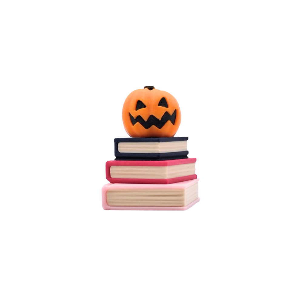 Book stack clicker with jack-o-lantern sensory fidget toy