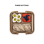 Toy lunch box with buttons containing food items on a white background