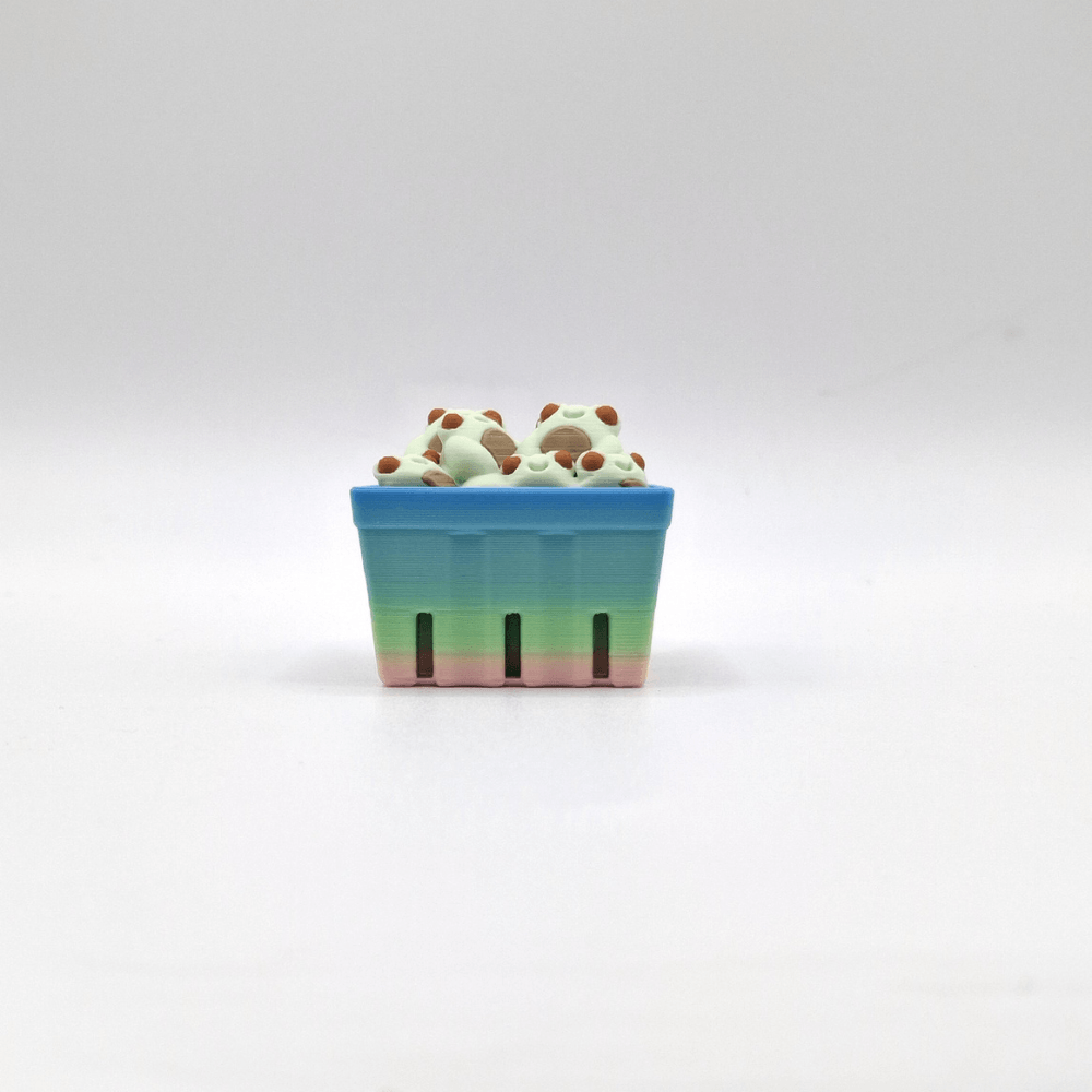 Basket of green frogs with a pastel rainbow basket